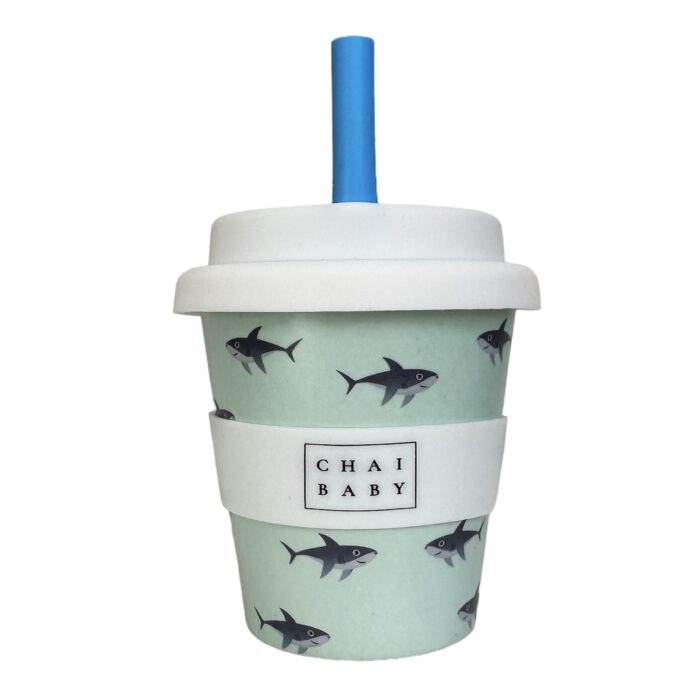 A babyccino cup with blue sharks and a blue background