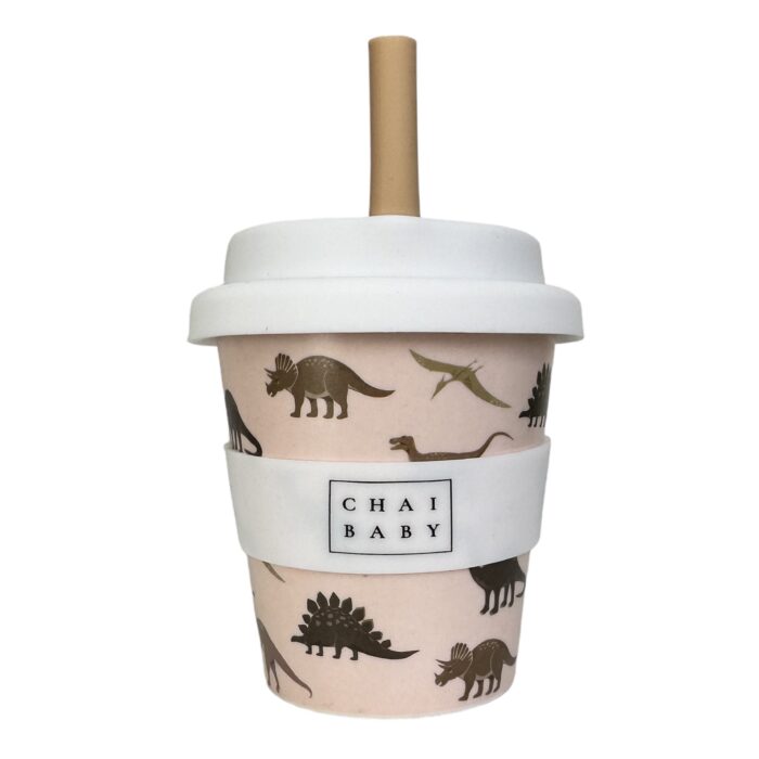 A babyccino cup with dinosaurs and beige background. Silicone lid and straw with a brown straw